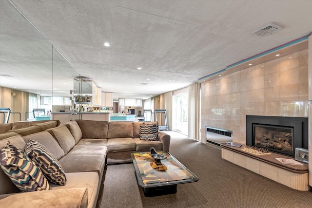 895 Cherry Ln, North Woodmere, NY 11581 - living room with carpet flooring, a tiled fireplace, and recessed lighting