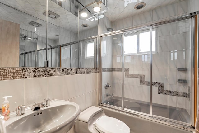 895 Cherry Ln, North Woodmere, NY 11581 - bathroom featuring tile walls and combined bath / shower with glass door