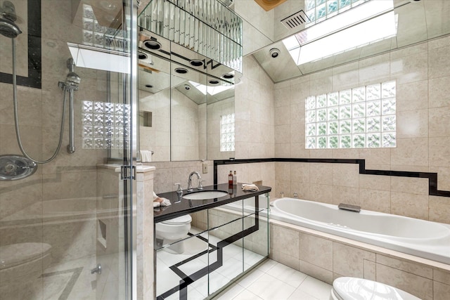 895 Cherry Ln, North Woodmere, NY 11581 - bathroom with tile walls, a stall shower, a bath, a skylight, and tile patterned floors