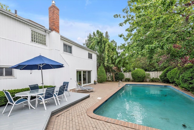 895 Cherry Ln, North Woodmere, NY 11581 - view of swimming pool featuring a fenced backyard, a patio, and outdoor dining space