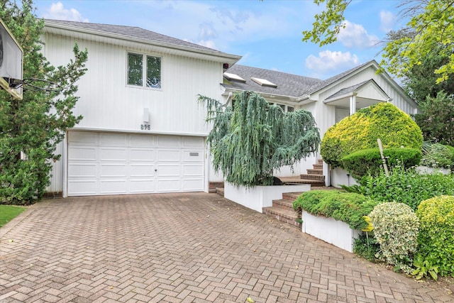 895 Cherry Ln, North Woodmere, NY 11581 - view of front of property with decorative driveway, a garage, and a shingled roof