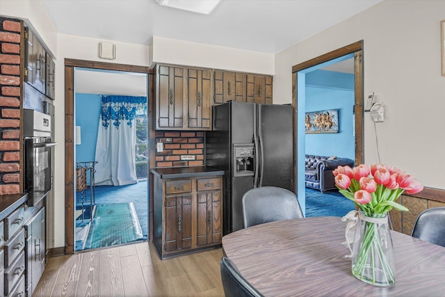 17 Edna Dr, Syosset, NY 11791 - kitchen with black appliances, light wood-style flooring, and dark countertops