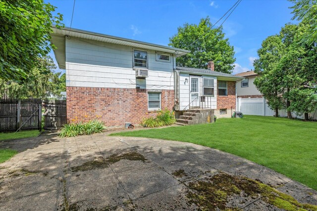 17 Edna Dr, Syosset, NY 11791 - back of house featuring brick siding, a chimney, and a patio area