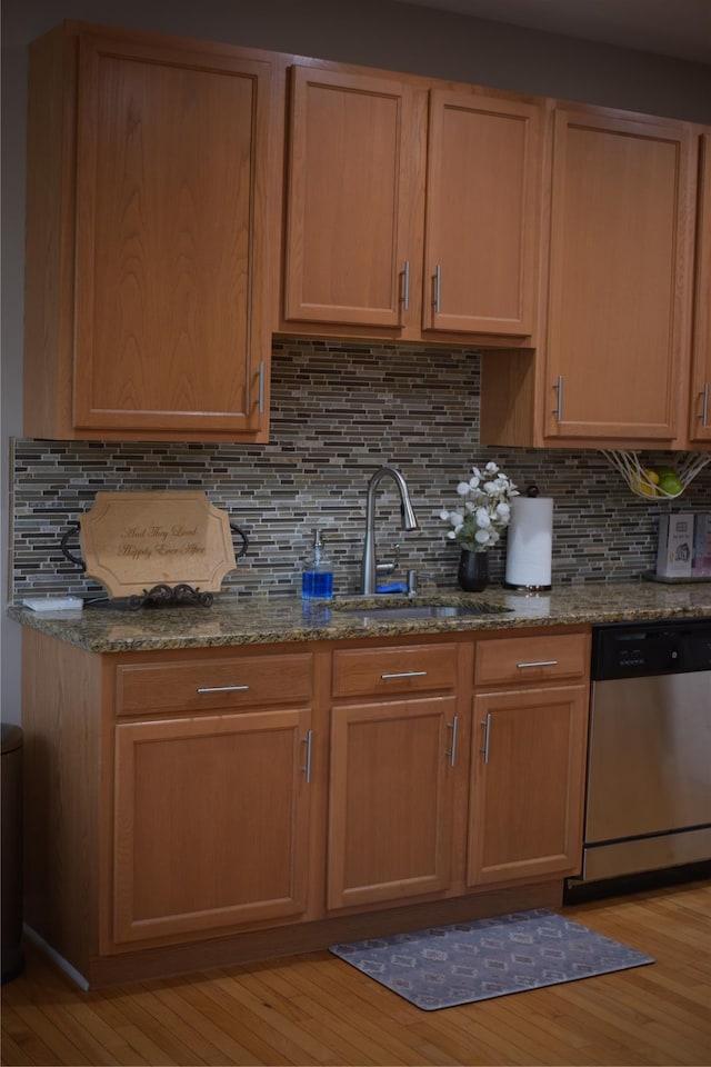 15 Cobblestone Ln, Middletown, NY 10940 - kitchen with stainless steel dishwasher, light wood-style floors, dark stone countertops, and tasteful backsplash