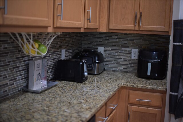 15 Cobblestone Ln, Middletown, NY 10940 - kitchen featuring backsplash and light stone countertops