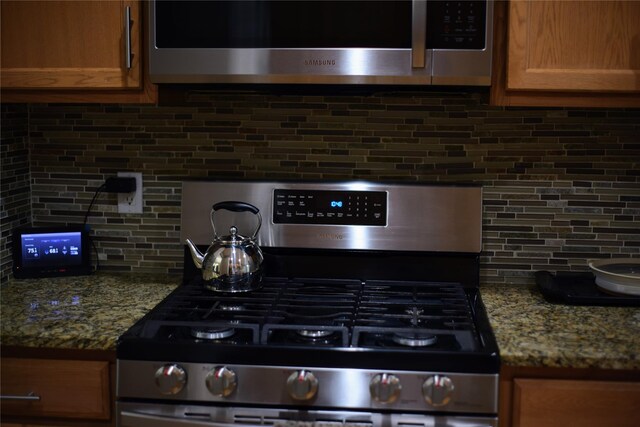15 Cobblestone Ln, Middletown, NY 10940 - kitchen view of stainless steel appliances, tasteful backsplash, and light stone countertops