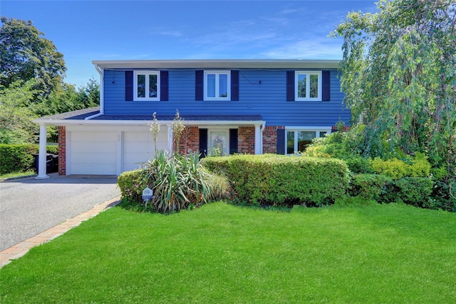25 Lloyd Ln, Nesconset, NY 11767 - traditional-style home featuring a front lawn, asphalt driveway, brick siding, and an attached garage