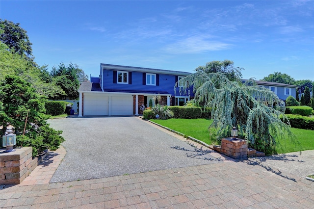 25 Lloyd Ln, Nesconset, NY 11767 - traditional-style home featuring driveway, a front lawn, a garage, and brick siding