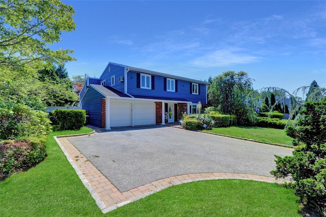 25 Lloyd Ln, Nesconset, NY 11767 - view of front of house featuring driveway, brick siding, a front lawn, and an attached garage