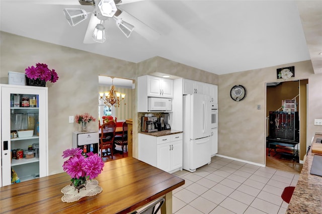 25 Lloyd Ln, Nesconset, NY 11767 - dining space featuring light tile patterned flooring, a ceiling fan, and a chandelier