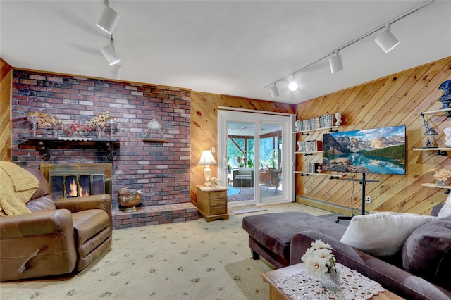 25 Lloyd Ln, Nesconset, NY 11767 - carpeted living room with rail lighting, wood walls, and a brick fireplace