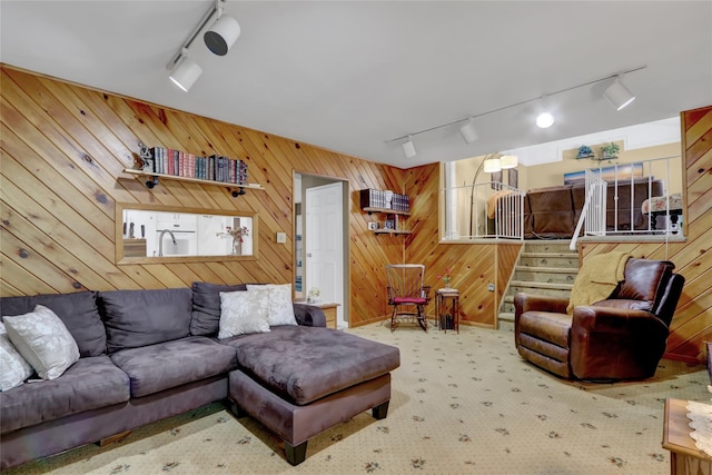 25 Lloyd Ln, Nesconset, NY 11767 - carpeted living area with rail lighting, wood walls, and stairs