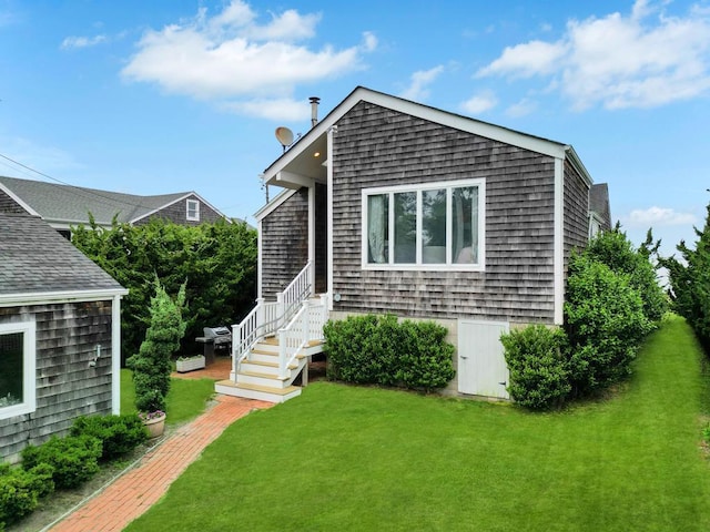15 Bayside Ave, East Quogue, NY 11942 - view of front of house with a front yard