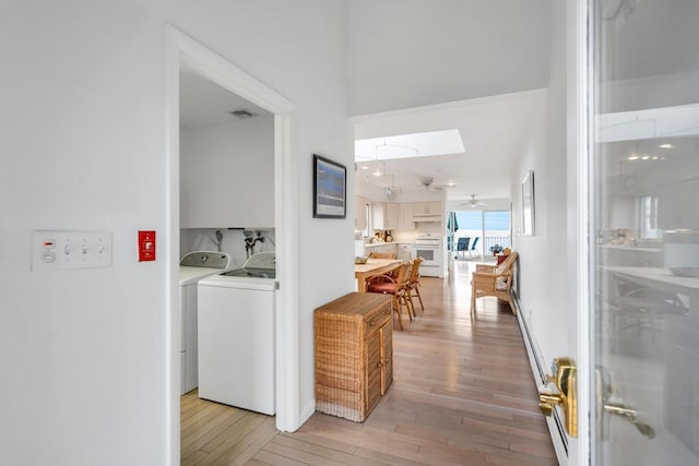 15 Bayside Ave, East Quogue, NY 11942 - corridor with washer and dryer, light wood-type flooring, and a skylight