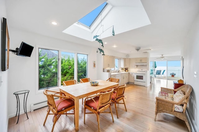 15 Bayside Ave, East Quogue, NY 11942 - dining area with a skylight, plenty of natural light, light wood-style floors, a baseboard heating unit, and recessed lighting