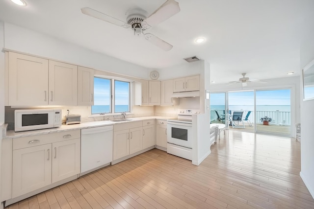 15 Bayside Ave, East Quogue, NY 11942 - kitchen featuring white appliances, a ceiling fan, plenty of natural light, light countertops, and recessed lighting
