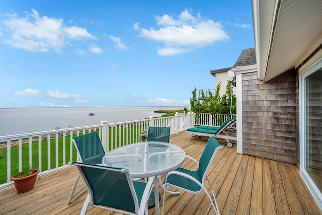 15 Bayside Ave, East Quogue, NY 11942 - wooden deck featuring a water view, outdoor dining area, and a lawn