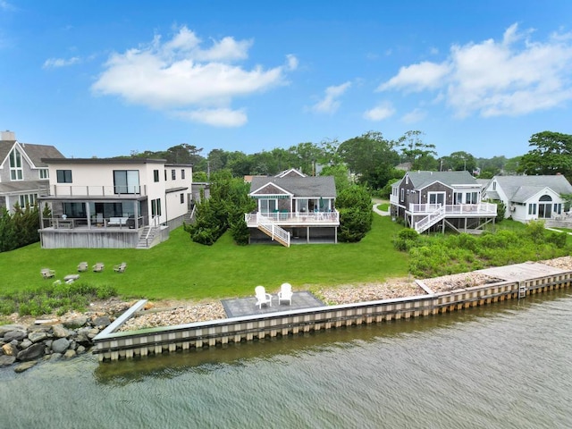 15 Bayside Ave, East Quogue, NY 11942 - rear view of house with stairs, a deck with water view, a yard, a residential view, and stucco siding