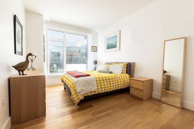 133 Bch 116th St Unit 4M, Rockaway Beach, NY 11694 - bedroom featuring light wood-type flooring and baseboards