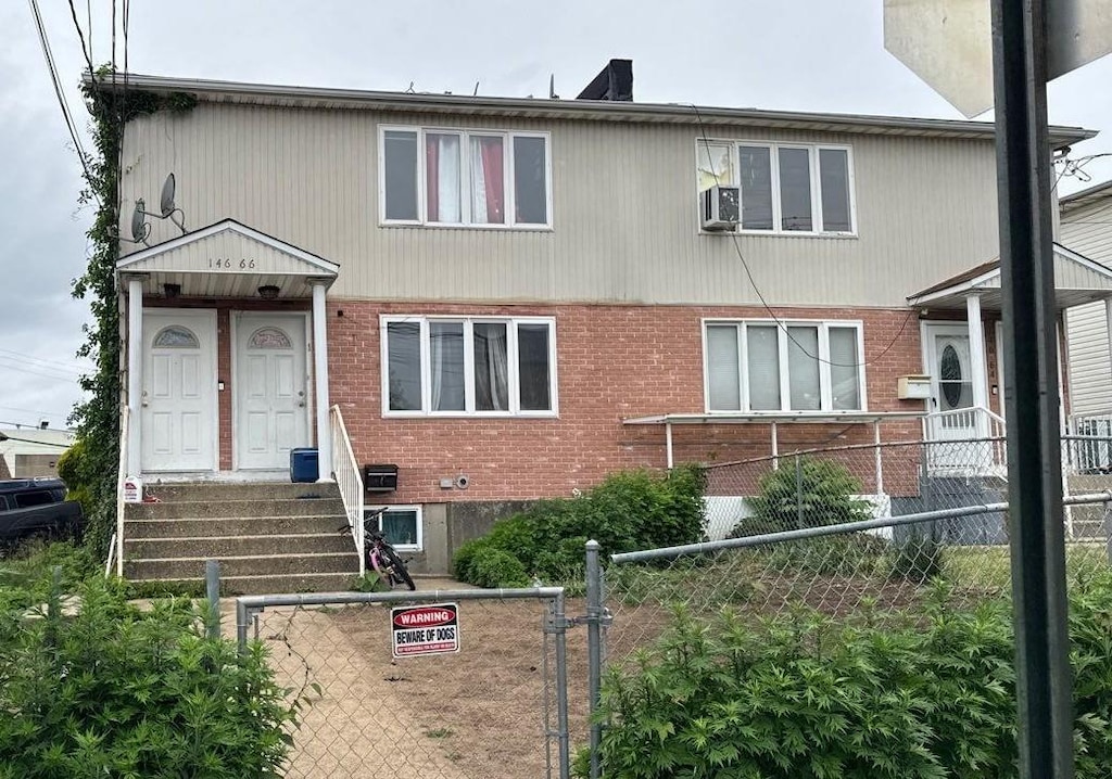 146-66 222nd St, Springfield Gardens, NY 11413 - view of property with brick siding, a fenced front yard, and a gate