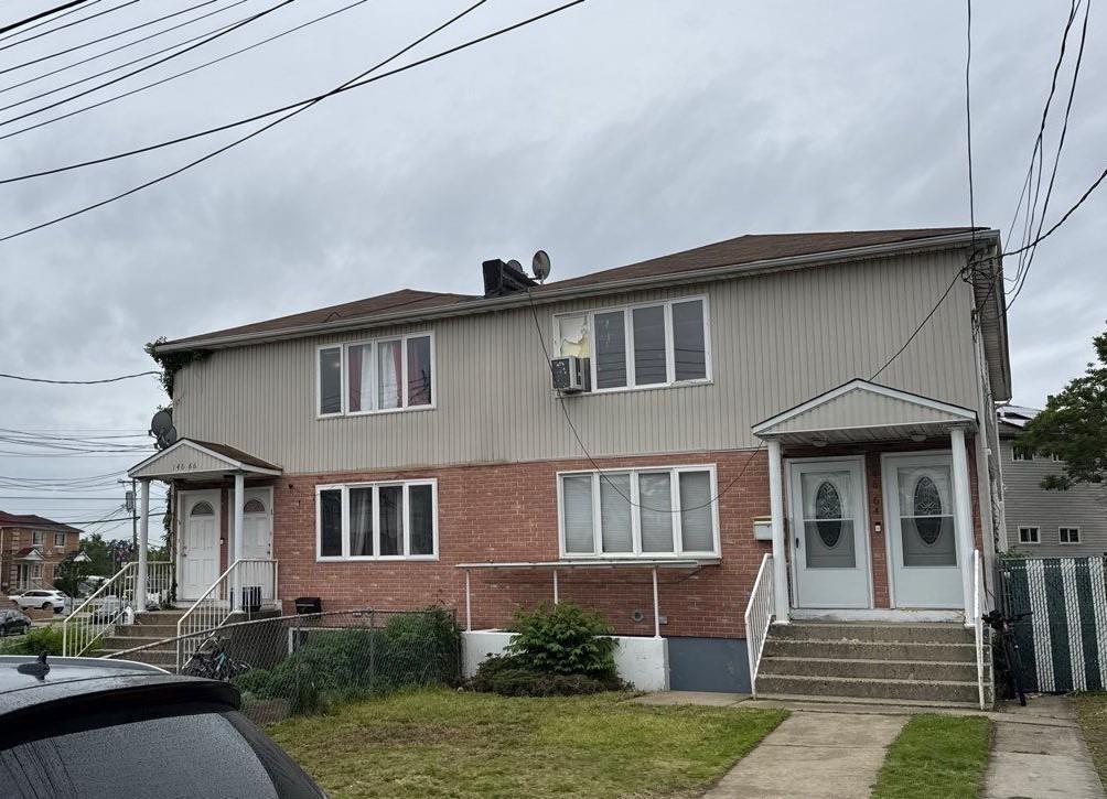 146-66 222nd St, Springfield Gardens, NY 11413 - townhome / multi-family property featuring brick siding and entry steps