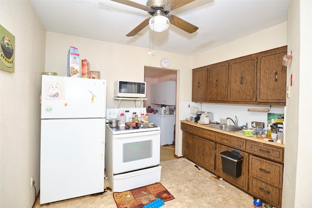 57 Hubbard Ave, Freeport, NY 11520 - kitchen featuring white appliances, washer / clothes dryer, a ceiling fan, light countertops, and brown cabinetry