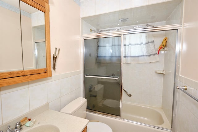 57 Hubbard Ave, Freeport, NY 11520 - full bathroom with tile walls, combined bath / shower with glass door, and vanity