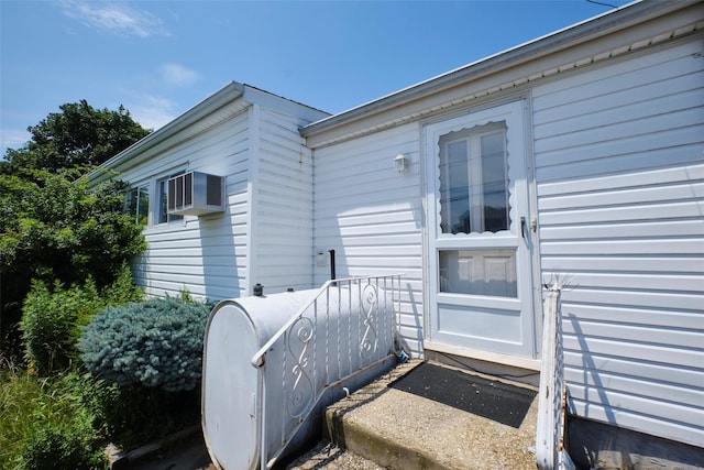 57 Hubbard Ave, Freeport, NY 11520 - view of exterior entry with oil tank and a wall unit AC