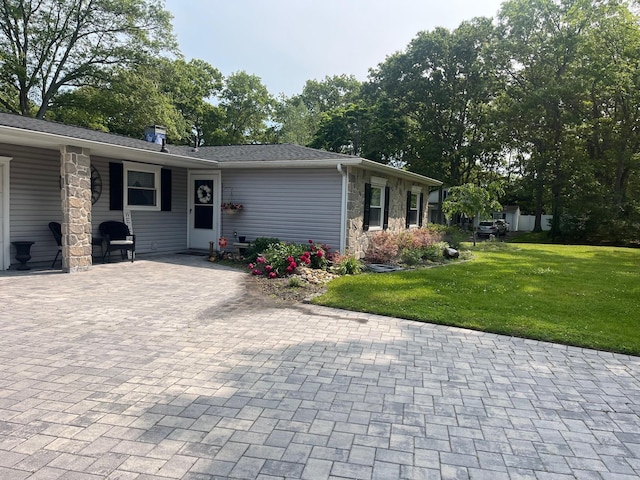 9 Songsparrow Ln, Centereach, NY 11720 - view of front of home featuring stone siding and a front yard