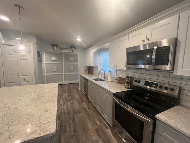 9 Songsparrow Ln, Centereach, NY 11720 - kitchen featuring appliances with stainless steel finishes, tasteful backsplash, dark wood finished floors, light stone counters, and lofted ceiling