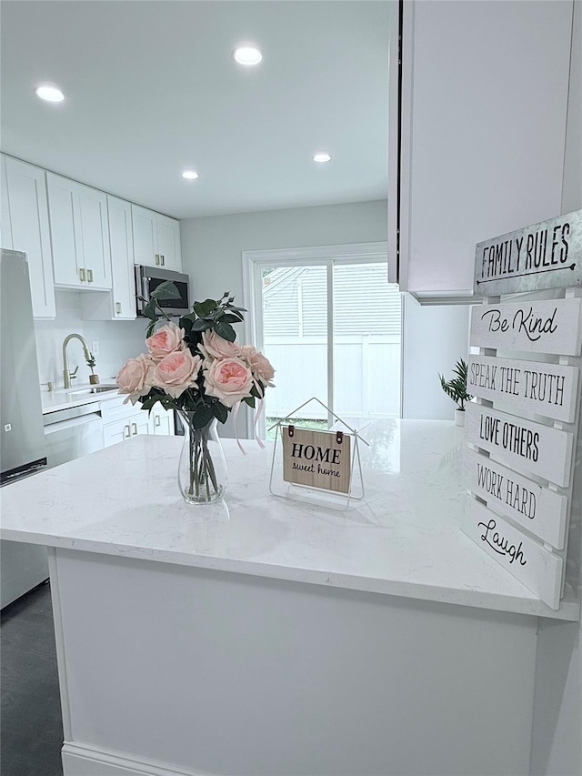 308 Hancock St, Brentwood, NY 11717 - kitchen with appliances with stainless steel finishes, white cabinetry, light stone countertops, and recessed lighting