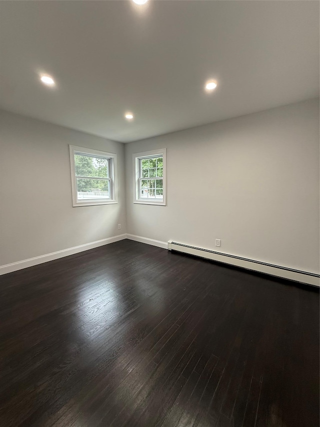 308 Hancock St, Brentwood, NY 11717 - spare room featuring baseboard heating, dark wood-style floors, and recessed lighting