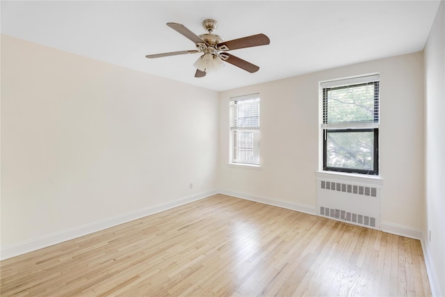302 96th St Unit 5A, Brooklyn, NY 11209 - spare room featuring radiator, wood finished floors, and ceiling fan