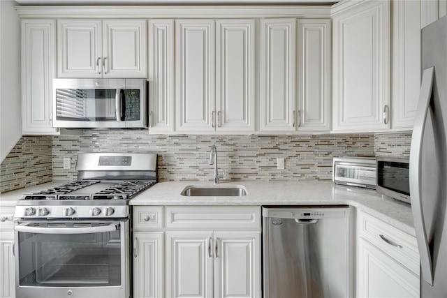 302 96th St Unit 5A, Brooklyn, NY 11209 - kitchen featuring stainless steel appliances, tasteful backsplash, light countertops, and white cabinetry