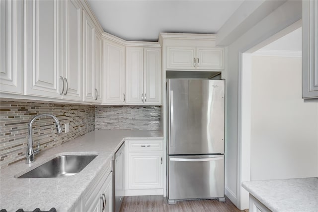 302 96th St Unit 5A, Brooklyn, NY 11209 - kitchen with stainless steel appliances, tasteful backsplash, white cabinets, and light stone counters