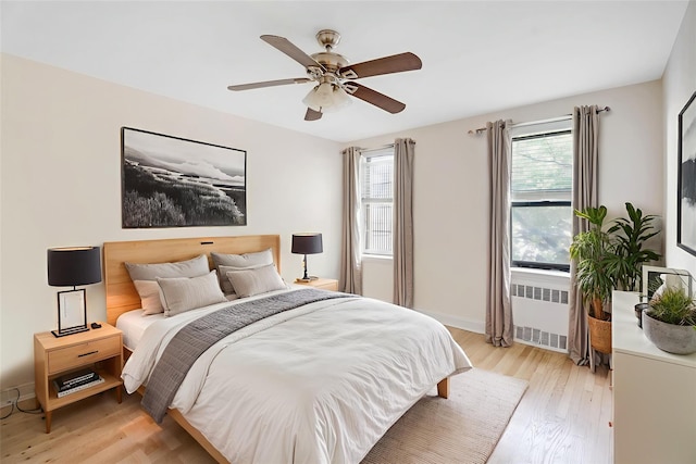 302 96th St Unit 5A, Brooklyn, NY 11209 - bedroom with radiator, multiple windows, and light wood-style flooring