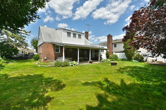 136 Euclid Ave, Massapequa, NY 11758 - back of house featuring a sunroom, a chimney, brick siding, and a patio