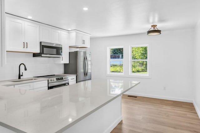 50 Appletree Dr, Saugerties, NY 12477 - kitchen featuring appliances with stainless steel finishes, decorative backsplash, recessed lighting, white cabinetry, and light stone countertops