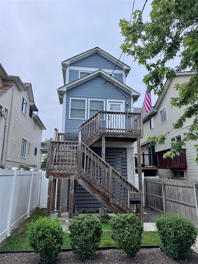 107 Baden Pl, Staten Island, NY 10306 - rear view of property with a fenced backyard, stairs, and a deck