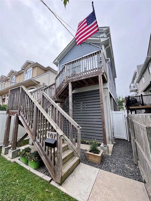 107 Baden Pl, Staten Island, NY 10306 - rear view of house featuring stairway, a fenced backyard, and a deck