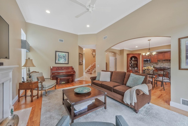 28 Hamlet Dr, Commack, NY 11725 - living area featuring arched walkways, light wood finished floors, ceiling fan, crown molding, and recessed lighting