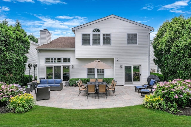 28 Hamlet Dr, Commack, NY 11725 - rear view of property with an outdoor hangout area, a patio, a chimney, a lawn, and roof with shingles