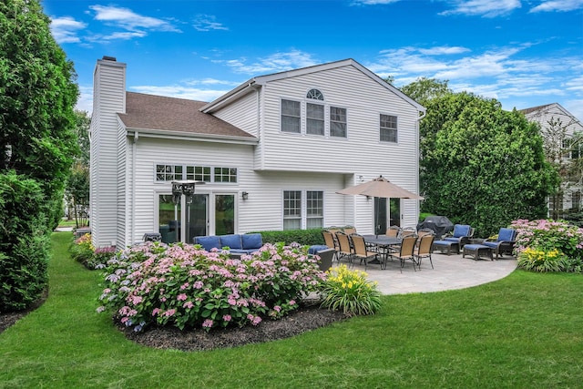 28 Hamlet Dr, Commack, NY 11725 - back of property featuring a chimney, a patio area, a yard, and roof with shingles