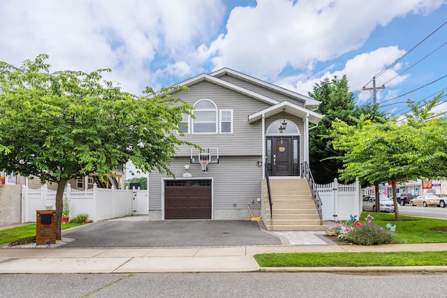 1200 Roger Rd, North Bellmore, NY 11710 - split foyer home featuring driveway, a garage, and a gate