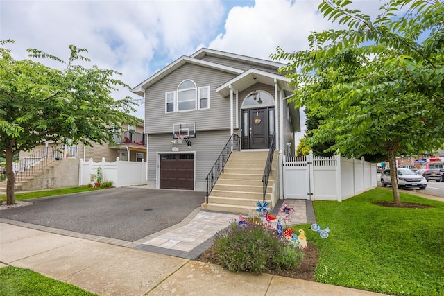 1200 Roger Rd, North Bellmore, NY 11710 - view of front of property with driveway, an attached garage, and stairway