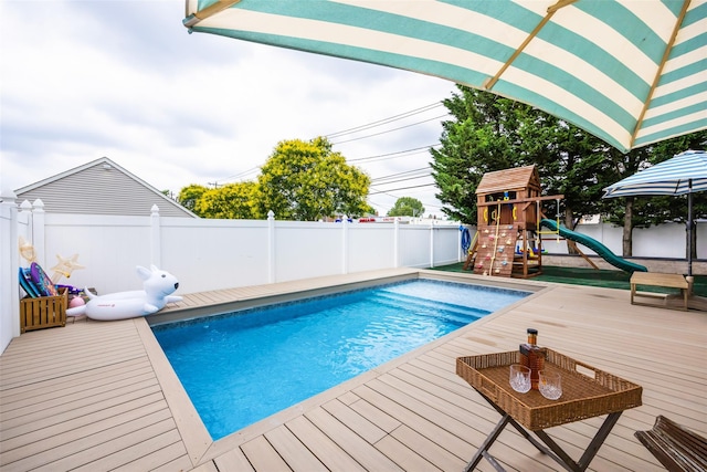 1200 Roger Rd, North Bellmore, NY 11710 - view of swimming pool with a fenced backyard, a playground, and a deck