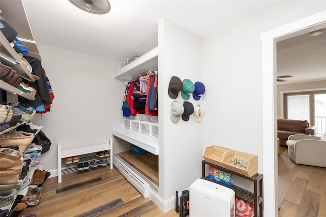 1200 Roger Rd, North Bellmore, NY 11710 - walk in closet with wood finished floors and baseboard heating