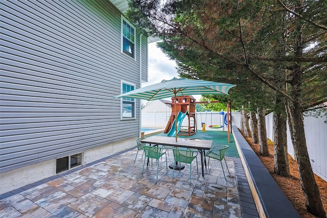 1200 Roger Rd, North Bellmore, NY 11710 - fenced backyard with a playground, outdoor dining area, and a patio