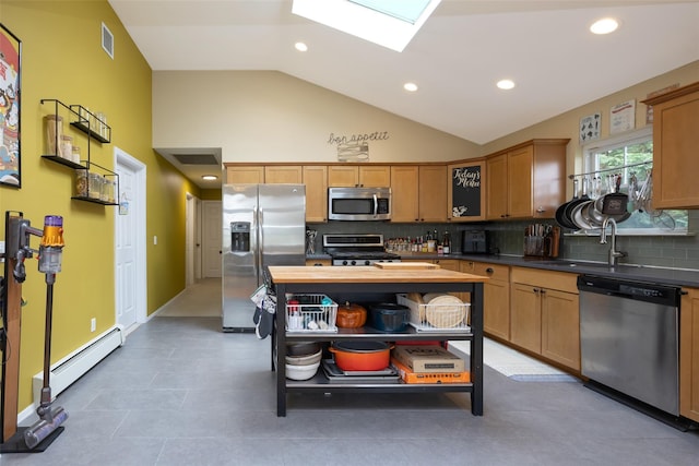 1200 Roger Rd, North Bellmore, NY 11710 - kitchen featuring stainless steel appliances, tasteful backsplash, a baseboard heating unit, a skylight, and recessed lighting