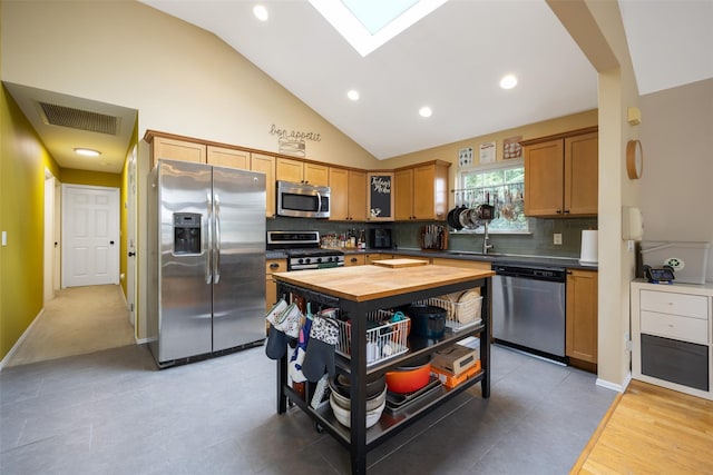 1200 Roger Rd, North Bellmore, NY 11710 - kitchen with stainless steel appliances, wood counters, vaulted ceiling, tasteful backsplash, and recessed lighting